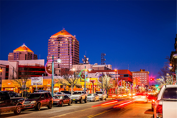 Cars driving through downtown Albuquerque at night